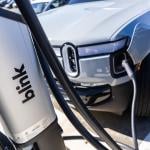 An EV charges from a Blink Charging station.