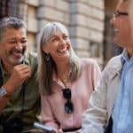 A group of senior friends laughing together on a day out.