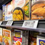 Digital price tags on display for the seasoning mix shelf in a grocery.