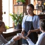 An angry couple disputing a complaint with a cafe waitress.