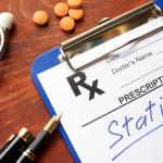 A clipboard with written prescription for 'statins'.