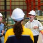 A senior engineering manager briefing a team in their industrial factory workplace.