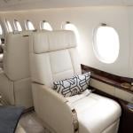 Cream-colored leather seats in a private business jet.