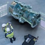 Aircraft engineers using augmented reality software for jet engine diagnostics.