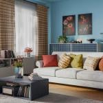 Interior of a modern living room with blue walls and a cozy furniture set.