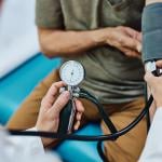 A senior man getting his blood pressure checked.