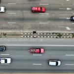 Aerial view of moving vehicles on a multi-lane highway.