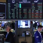 Traders work on the floor of the New York Stock Exchange during morning trading on January 06, 2026 in New York City. 