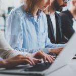 A row of employees working in an office.