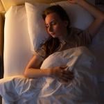 A young woman sleeping on her back.