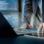 Businessman using laptop illustrated with AI software technology graphics.