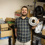 Aleks Maricq, a research associate at the University of Utah, holds the 9-track magnetic tape marked as containing a copy of UNIX Version 4, a foundational computer operating system, that he found in a storage room.