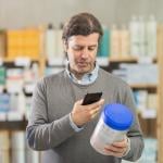 A man scanning a baby food's information while shopping.