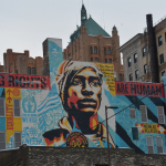 A Shepard Fairey-designed voting-rights mural rises over downtown Milwaukee, where voters and election officials remain under scrutiny for their election practices.