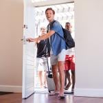 A group of male friends arriving at a rental home.
