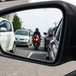 A red, sporty, motorcycle moves between the lanes.
