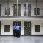 Guards prepare to escort an immigrant detainee from his 'segregation cell' back into the general population at the Adelanto Detention Facility on November 15, 2013 in Adelanto, California.