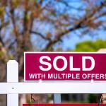A 'sold with multiple offers' sign for a property.