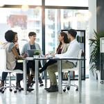 A group of businesspeople having a meeting together in a modern office