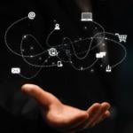 A network of marketing and communication concept icons over a person's hand.