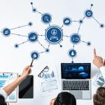 A business team collaborating and illustrated utilizing a CRM tool.