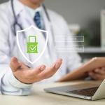 A doctor's hand holding up a graphic of medical data login as a concept of medical data security.