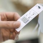 Close up on a woman's hand checking out a bra product tag.