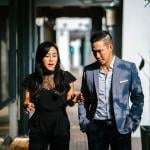 A pair of business people walking along a corridor.
