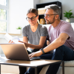 Couple doing taxes on a computer.
