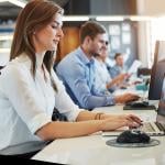 Business employees working in front of computers in their office.