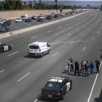 Crime scene investigators gather on the side of California Highway where a 6-year-old boy was fatally shot during a road rage incident on 55 Freeway in Orange.