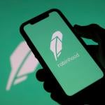 Robinhood, a financial investing app, and its logo displayed on a smartphone.