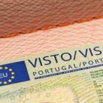 A Portuguese visa vignette on a passport with the European Union symbol.
