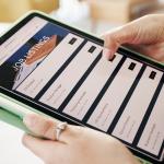 Person browsing job listings online using a tablet.