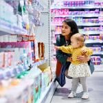A mother and her young daughter shopping in a drugstore.