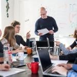 A business team brainstorming in a meeting room.