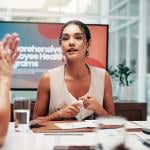 A businesswoman leading a boardroom meeting.