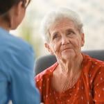 A senior woman facing her nurse.