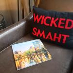 A 'wicked smaht' pillow merchandise beside a travel magazine about Boston, Massachusetts.