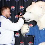 American Professional footballer Tyler Shough with Pepsi and the cola-loving polar bear during Super Bowl LX in San Francisco, California.
