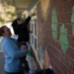 In the background, Amanda Smith, a behavioral specialist, holds up a child outside the Moore Learning Preschool & Childcare Center in Elk Grove on February 6, 2026.