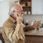 A happy senior man talking on the phone.