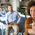 Employees collaborating during a meeting in the office.