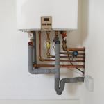 A modern gas boiler on a white wall.
