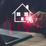 Person using a laptop illustrated with graphics showing concept of lower costs of housing.