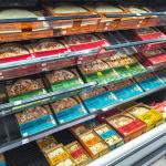 Frozen pizza section at a grocery store.