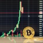 A golden bitcoin in front of stock exchange charts.