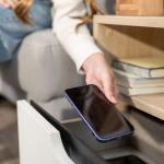 A person putting a smartphone inside a drawer.