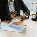 A legal counsel presenting a contract to a client in a law office.