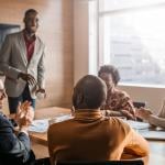 Coworkers enjoying a lighthearted moment during an office meeting.
